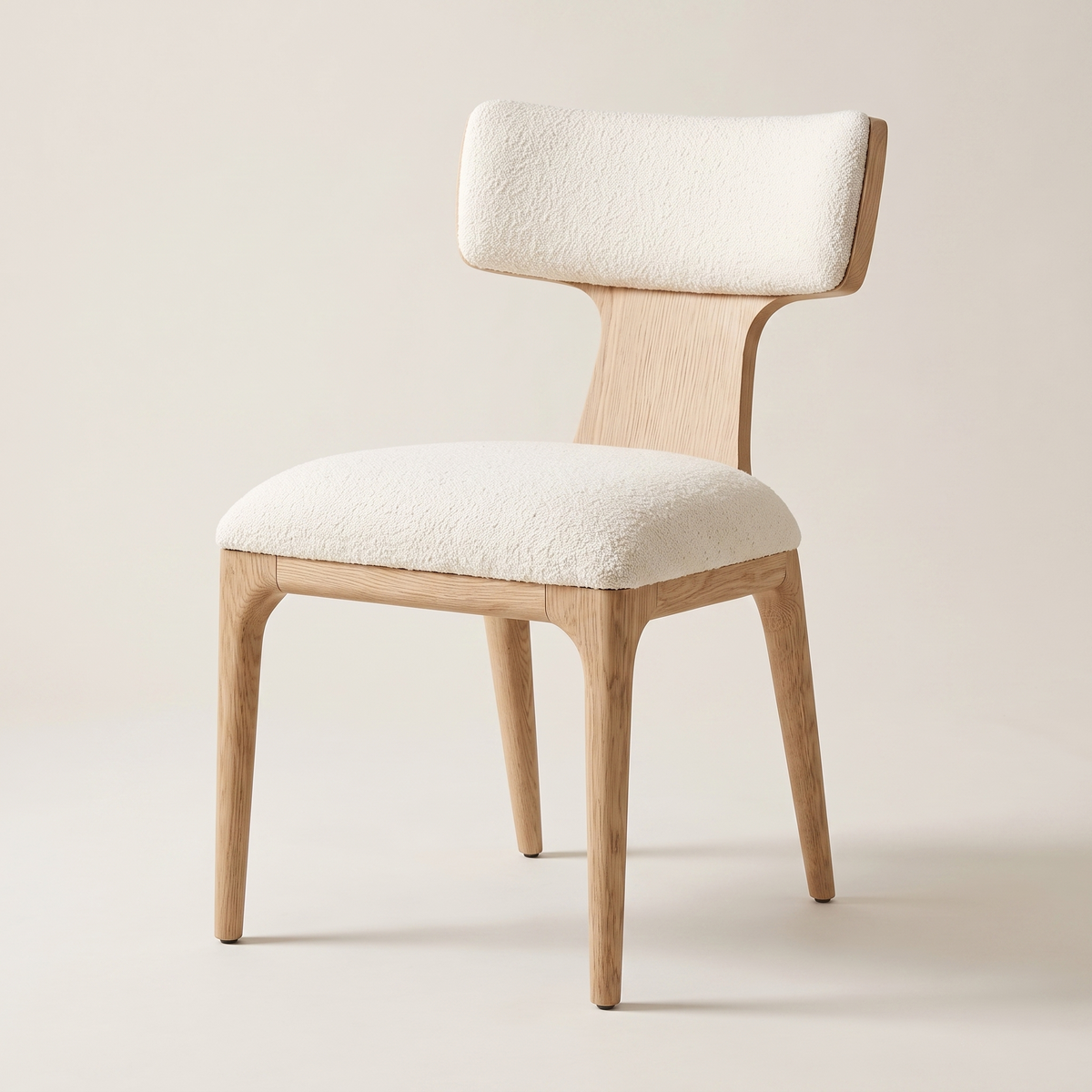 Cream boucle wingback dining chair with oak frame