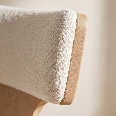 Close detail of the boucle upholstery and oak frame
