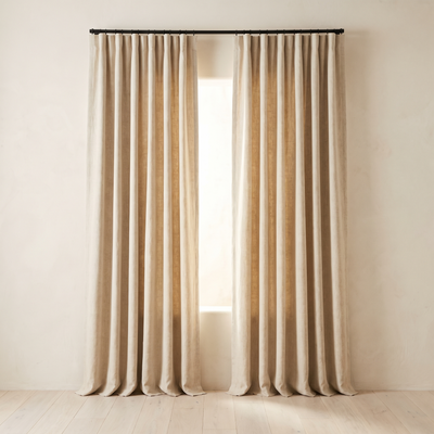 Oatmeal linen blackout curtains hung at a window