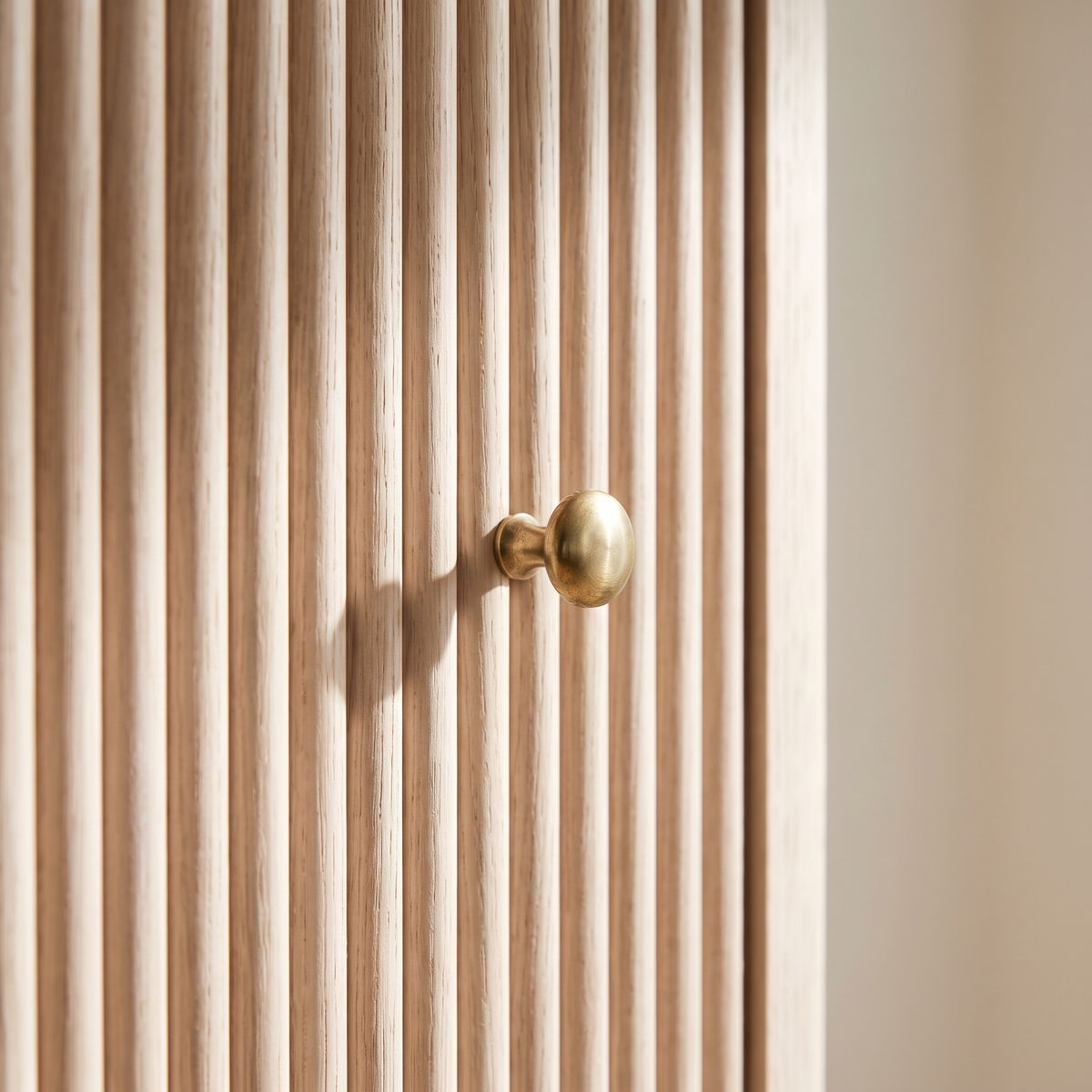 Detail of the brass knob against the fluted oak door