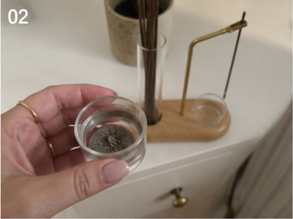 Lifting the glass ash cup out, ash collected inside